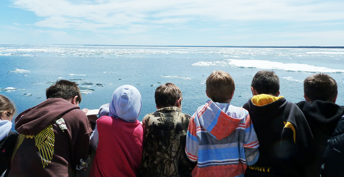 Students looking at the frozen lake