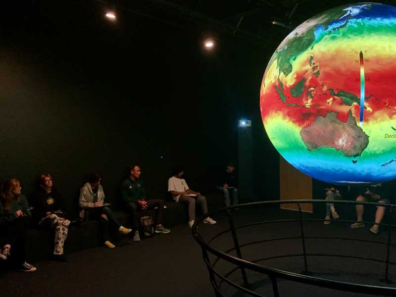 High school students make predictions about future pH levels in the Great Lakes while seeing atmospheric carbon dioxide datasets on the Science on a Sphere.